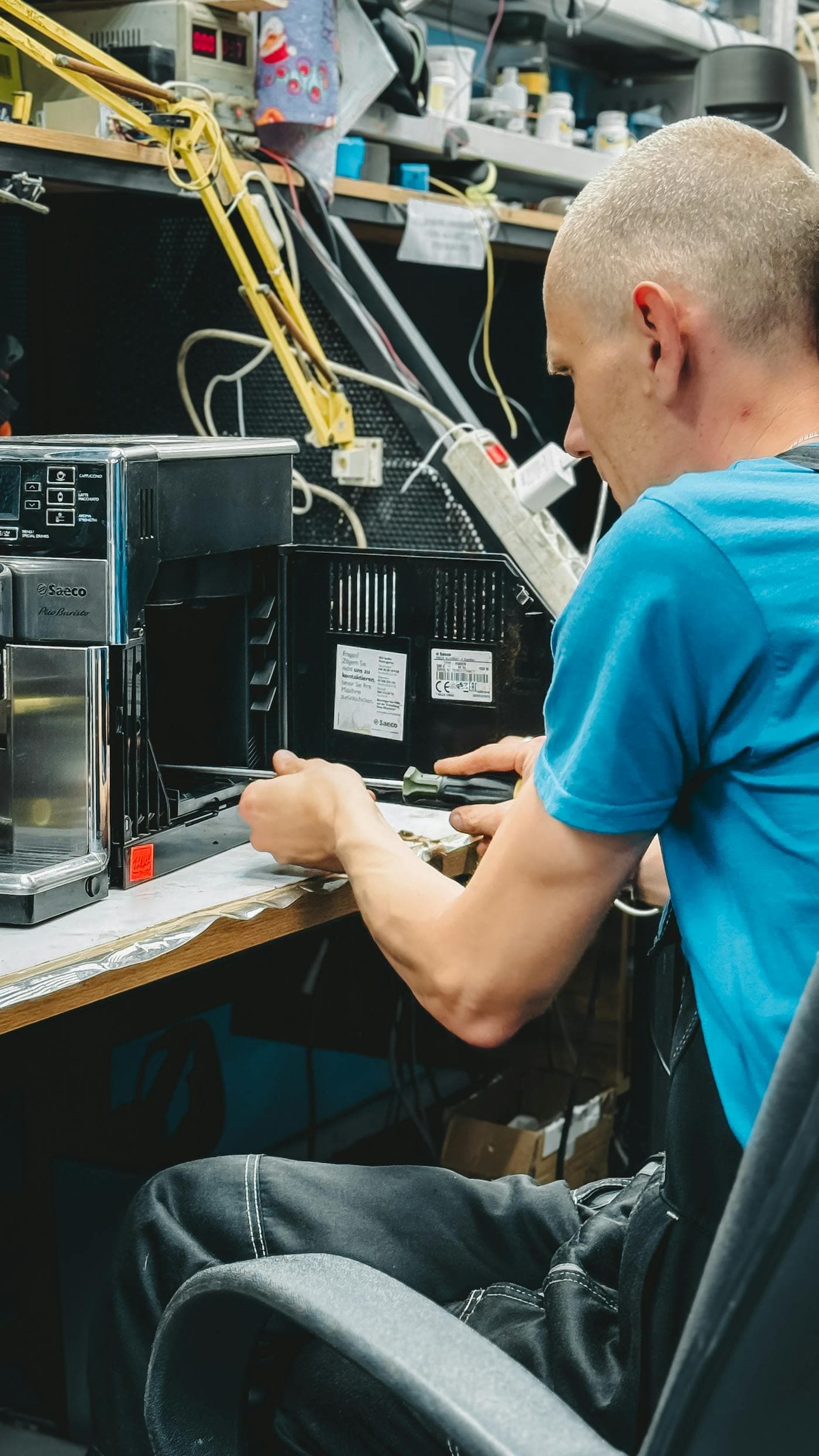 PartsCorp consultant servicing a commercial coffee machine at the workbench